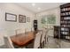 Dining room showcasing a large wooden table with seating for eight, alongside built-in bookshelves at 1798 Lakewood Dr, Henderson, NV 89012