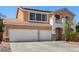 Two-story home featuring a two-car garage and a small balcony with white railings at 1798 Lakewood Dr, Henderson, NV 89012