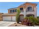 Charming two-story house featuring a balcony, desert landscaping, and a two-car garage at 1798 Lakewood Dr, Henderson, NV 89012