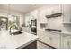Bright kitchen features white cabinets, stainless appliances, and a quartz-topped island at 1798 Lakewood Dr, Henderson, NV 89012