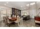 Open living and dining area featuring a large bookcase, dining table and chairs, and comfortable sofas at 1798 Lakewood Dr, Henderson, NV 89012