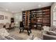 Cozy living room with large bookshelf with ladder and dining area at 1798 Lakewood Dr, Henderson, NV 89012