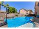 Sparkling pool featuring a spa and basketball hoop in a well-maintained backyard with lush landscaping and palm trees at 1798 Lakewood Dr, Henderson, NV 89012