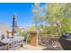 Charming balcony with an umbrella-covered table and views of lush green landscaping at 1844 Ghost Trace Ave, Las Vegas, NV 89183