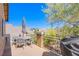 Charming balcony with an umbrella-covered table and views of lush green landscaping at 1844 Ghost Trace Ave, Las Vegas, NV 89183