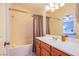 Bathroom with a shower-tub combo, white vanity, and a view of an adjacent bedroom at 1844 Ghost Trace Ave, Las Vegas, NV 89183