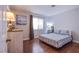 Cozy bedroom with wood-look floors, a comfortable bed, and a serene atmosphere at 1844 Ghost Trace Ave, Las Vegas, NV 89183