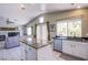 Open kitchen showcasing center island with granite countertop, leading to the living room area at 1844 Ghost Trace Ave, Las Vegas, NV 89183