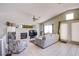 Open concept living room with tiled floors, fireplace, and a wall of windows at 1844 Ghost Trace Ave, Las Vegas, NV 89183
