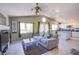 Bright living room with tile floors, high ceilings, and open layout to the kitchen at 1844 Ghost Trace Ave, Las Vegas, NV 89183