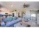 Living room flowing into kitchen, tiled flooring, and staircase to the second floor at 1844 Ghost Trace Ave, Las Vegas, NV 89183