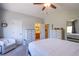 Spacious main bedroom with neutral decor, a ceiling fan, and carpeted floors at 1844 Ghost Trace Ave, Las Vegas, NV 89183