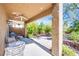 A backyard patio featuring a ceiling fan, lush vegetation, lounge chairs, and privacy at 1844 Ghost Trace Ave, Las Vegas, NV 89183
