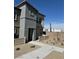Two-story home featuring modern architecture, neutral color scheme, and simple landscaping with a clear sky background at 1900 Arietta Vista St, Henderson, NV 89044