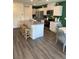 Modern kitchen with white cabinetry, stainless steel appliances, and a center island with bar seating at 1900 Arietta Vista St, Henderson, NV 89044