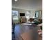Bright living room with modern decor, comfortable seating, and natural light from large windows overlooking the neighborhood at 1900 Arietta Vista St, Henderson, NV 89044