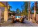 Backyard featuring a cozy firepit and seating next to a refreshing pool at 2008 Winter Wind St, Las Vegas, NV 89134