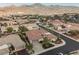 Aerial view of a neighborhood showcasing well-maintained homes with tile roofs and mountain views at 2080 Powder Springs St, Henderson, NV 89052