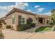Exterior view of a single-story house with manicured landscaping and a covered patio at 2080 Powder Springs St, Henderson, NV 89052