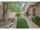 Inviting backyard with artificial grass, stone accents, and a covered patio for outdoor enjoyment at 2080 Powder Springs St, Henderson, NV 89052