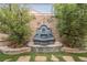 Backyard with a charming water feature surrounded by manicured greenery and stone detailing at 2080 Powder Springs St, Henderson, NV 89052