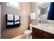 Bathroom with vanity, toilet, decorative towels, and a framed mirror at 2080 Powder Springs St, Henderson, NV 89052