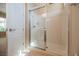 Modern bathroom showcasing a glass-enclosed shower with a neutral-toned interior and tiled floor at 2080 Powder Springs St, Henderson, NV 89052