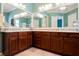 Bright bathroom featuring a dual sink vanity, tile flooring, and a large mirror at 2080 Powder Springs St, Henderson, NV 89052
