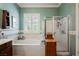 A luxurious bathroom includes a soaking tub, a glass-enclosed shower, and elegant floral wallpaper at 2080 Powder Springs St, Henderson, NV 89052