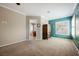 A bright bedroom with neutral walls and a green accent wall, showcasing plantation shutters and an armoire at 2080 Powder Springs St, Henderson, NV 89052