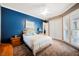 Bedroom featuring a vibrant blue accent wall, shutters, and a ceiling fan at 2080 Powder Springs St, Henderson, NV 89052
