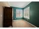A serene room with plantation shutters on the window and a dark green accent wall at 2080 Powder Springs St, Henderson, NV 89052