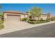 Charming single-story home with a well-manicured lawn, mature landscaping, and a two-car garage at 2080 Powder Springs St, Henderson, NV 89052