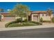Charming single-story home with a well-manicured lawn, mature landscaping, and a three-car garage at 2080 Powder Springs St, Henderson, NV 89052