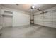 Spacious garage with epoxy flooring, built-in storage cabinets, and an automatic door at 2080 Powder Springs St, Henderson, NV 89052