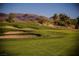 Scenic golf course with lush green fairways and a challenging sand trap, set against a backdrop of rolling hills at 2080 Powder Springs St, Henderson, NV 89052