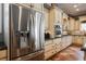 A view of the stainless steel refrigerator in this gourmet kitchen with custom cabinetry at 2080 Powder Springs St, Henderson, NV 89052