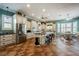 Spacious kitchen with white cabinets, stainless steel appliances, granite countertops, and an island with bar seating at 2080 Powder Springs St, Henderson, NV 89052