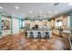 Open concept kitchen with granite countertops, tile floors, island and custom cabinetry at 2080 Powder Springs St, Henderson, NV 89052