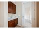 Convenient laundry room with sink, storage cabinets, and easy access to the patio for added functionality at 2080 Powder Springs St, Henderson, NV 89052