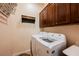 Laundry room with washer and dryer beneath wooden cabinets for storage at 2080 Powder Springs St, Henderson, NV 89052