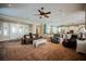 A spacious living room featuring a ceiling fan and entry to the kitchen at 2080 Powder Springs St, Henderson, NV 89052