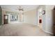 A large living area includes neutral carpeting, access to the backyard, and views of an attached bathroom at 2080 Powder Springs St, Henderson, NV 89052
