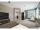 A beautifully staged primary bedroom shows an ensuite bathroom, stylish furnishings, and plantation shutters at 2080 Powder Springs St, Henderson, NV 89052