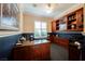 Well-lit office space with built-in shelves and storage cabinets with dark wood at 2080 Powder Springs St, Henderson, NV 89052