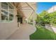 Covered patio area with an outdoor kitchen, overhead shade structure and manicured landscaping at 2080 Powder Springs St, Henderson, NV 89052