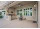 Covered patio featuring a built-in grill, ceiling fan, and neutral finishes for stylish outdoor living at 2080 Powder Springs St, Henderson, NV 89052