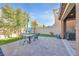 Outdoor patio area featuring brick pavers, a blue umbrella, and a grill at 2194 Trivero St, Henderson, NV 89044
