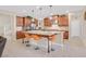 An island kitchen featuring granite countertops, updated stainless steel appliances, and wooden cabinetry at 2194 Trivero St, Henderson, NV 89044