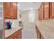 Cozy kitchen with granite countertops, wood cabinetry, and stainless steel appliances at 2194 Trivero St, Henderson, NV 89044